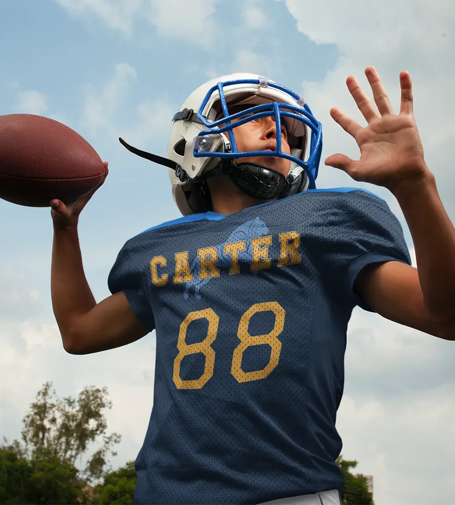 Football player wearing a personalized jersey with a custom player name and number on the front.