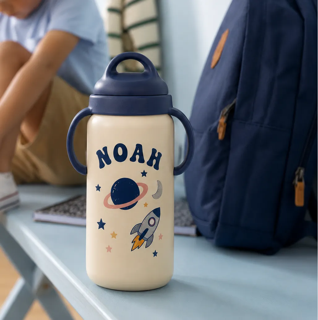 Personalized kids water bottle with a custom name and space-themed clipart.