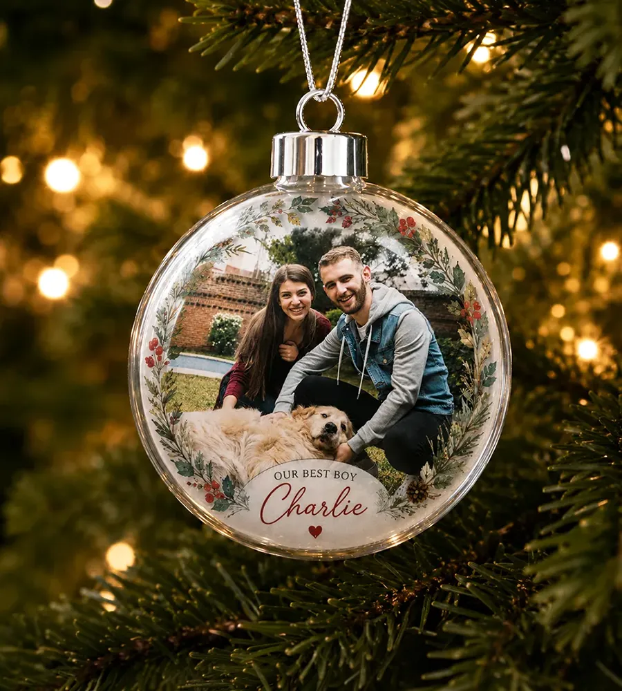 Personalized clear acrylic ball ornament featuring a custom family photo and pet name.