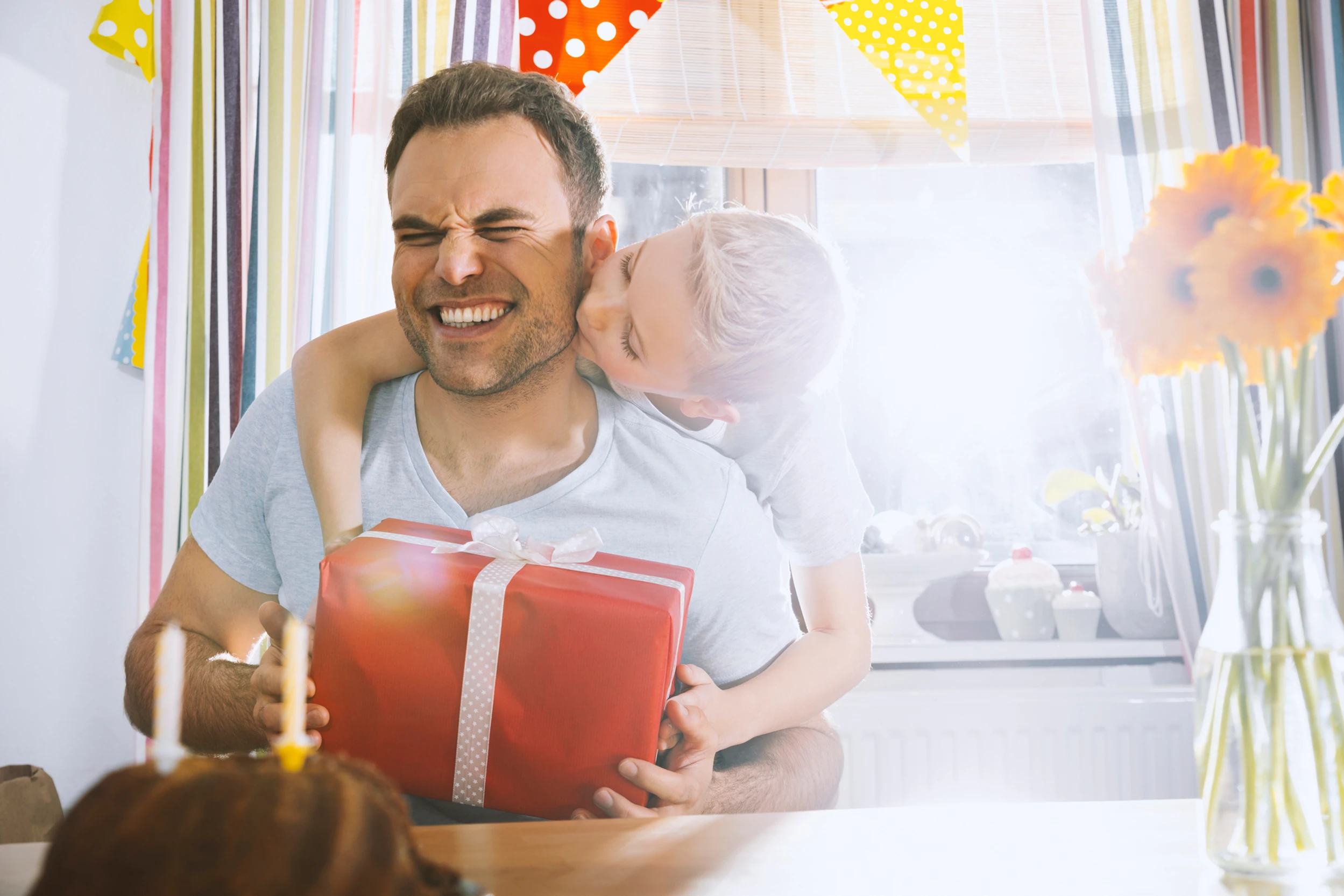 Girl hugging her dad with a present