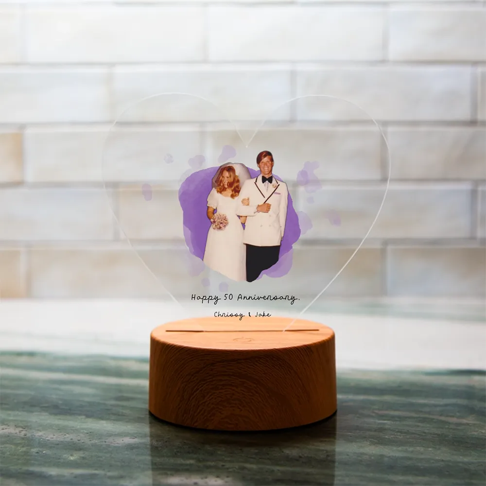 Personalized heart-shaped LED acrylic plaque featuring a vintage wedding photo and a 50th anniversary celebration design.