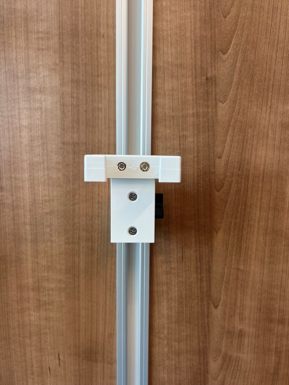 Photo of Mounting Plate with holder for owner provided pillow speaker or nurse call (Crest Healthcare and Curbell Medical Style) -- patient angled phone handset (Med-Pat) -- mount on Amico Vertical Channel