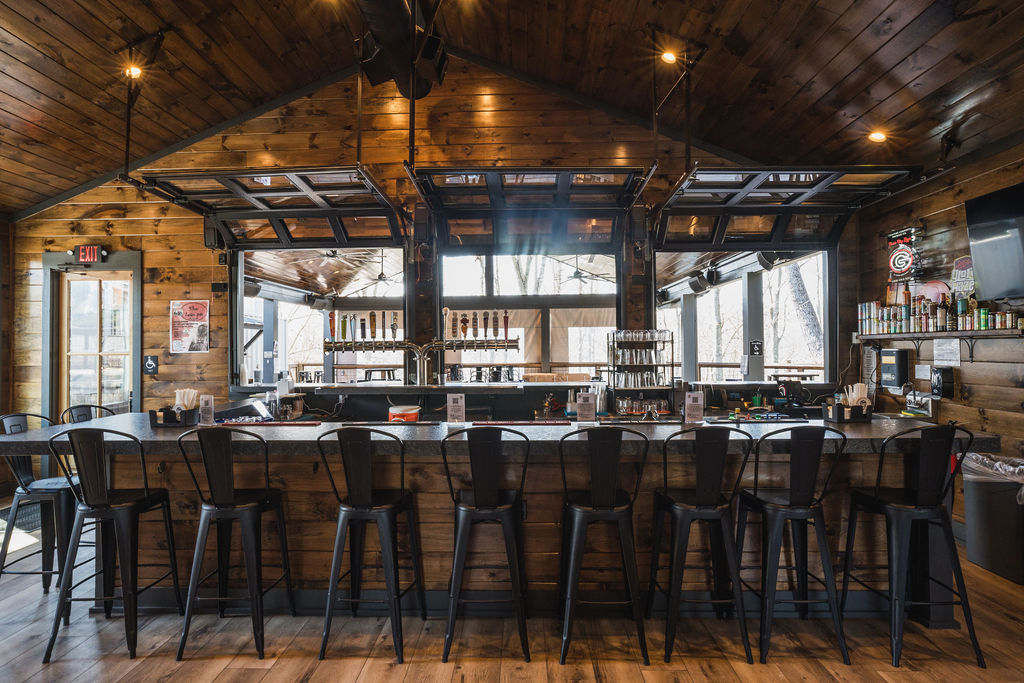 An industrial-chic beer garden in Canton, GA, blending a container kitchen with vibrant gathering spaces for music, events, and community.