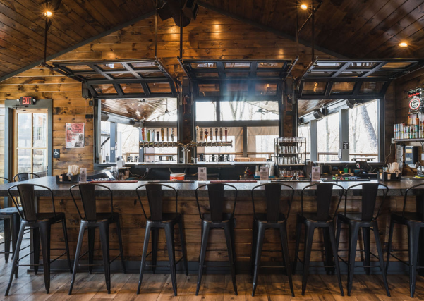 An industrial-chic beer garden in Canton, GA, blending a container kitchen with vibrant gathering spaces for music, events, and community.