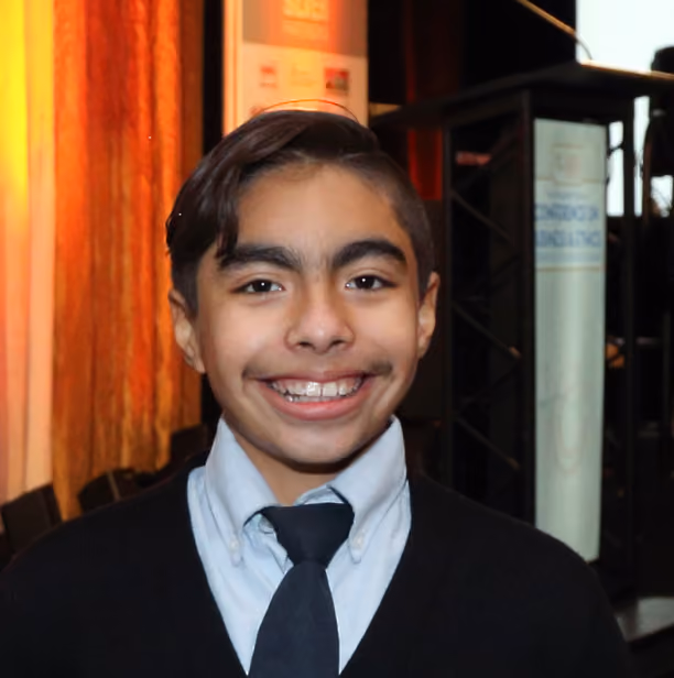 A young child smiling at the camera