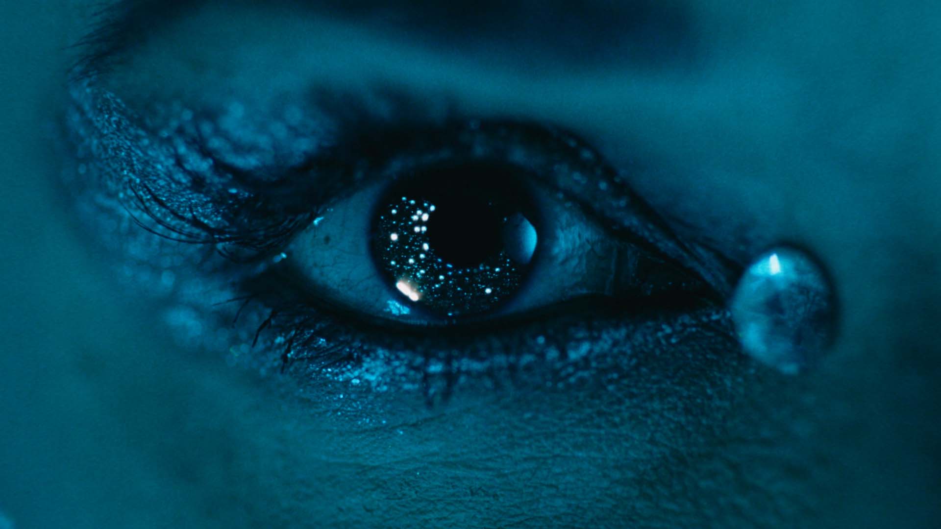 extreme close-up of an eye with a single tear in blue light, Motorola commercial