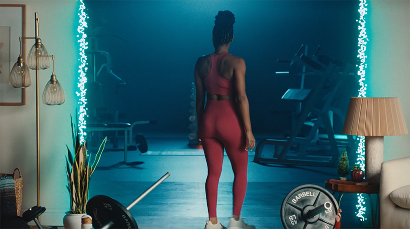 woman in a neon-lit home gym, Samsung fitness commercial