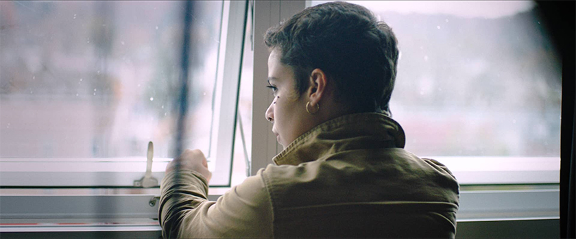 man gazing out a bright window, OUCU spot