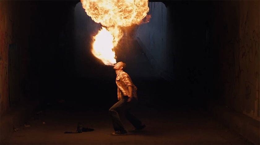 performer breathing fire in a dark warehouse, Levi's spot