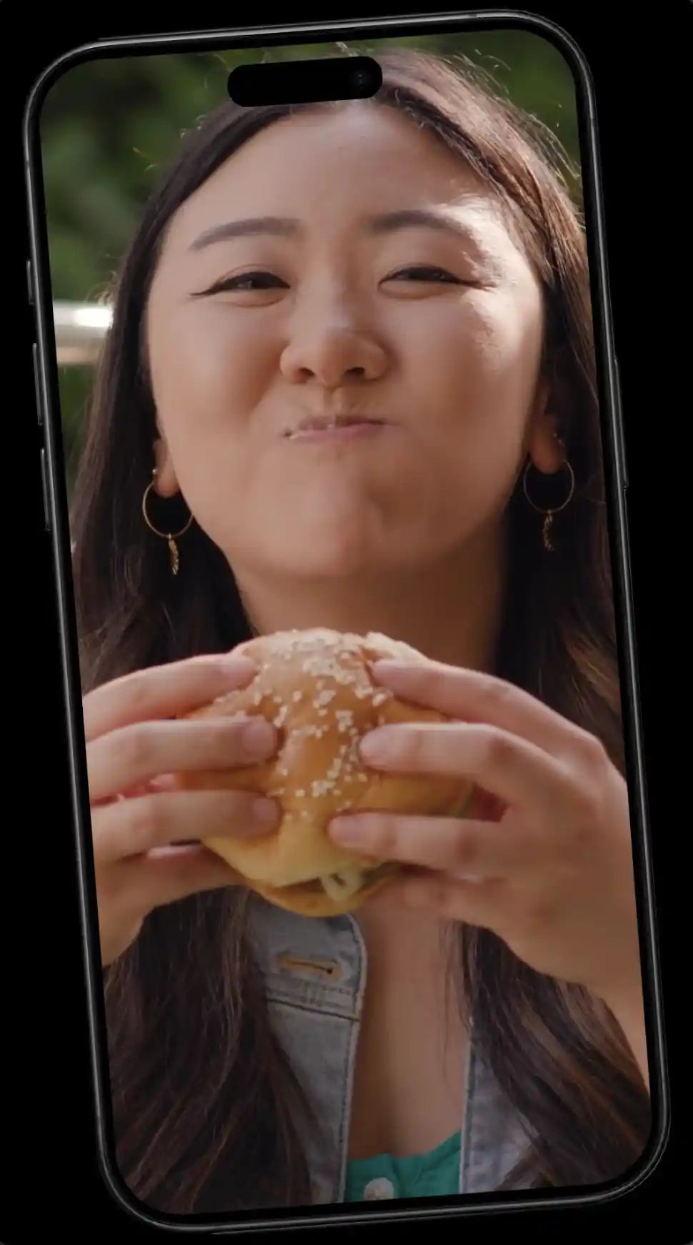ugc-style phone video of a woman eating a burger, Incogmeato