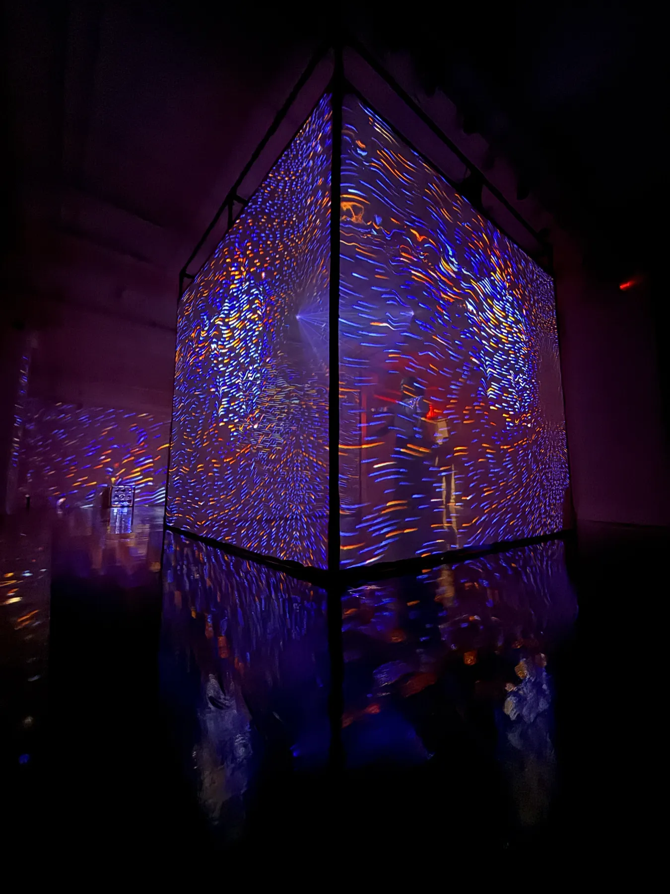 the projection cube glowing with colorful patterns