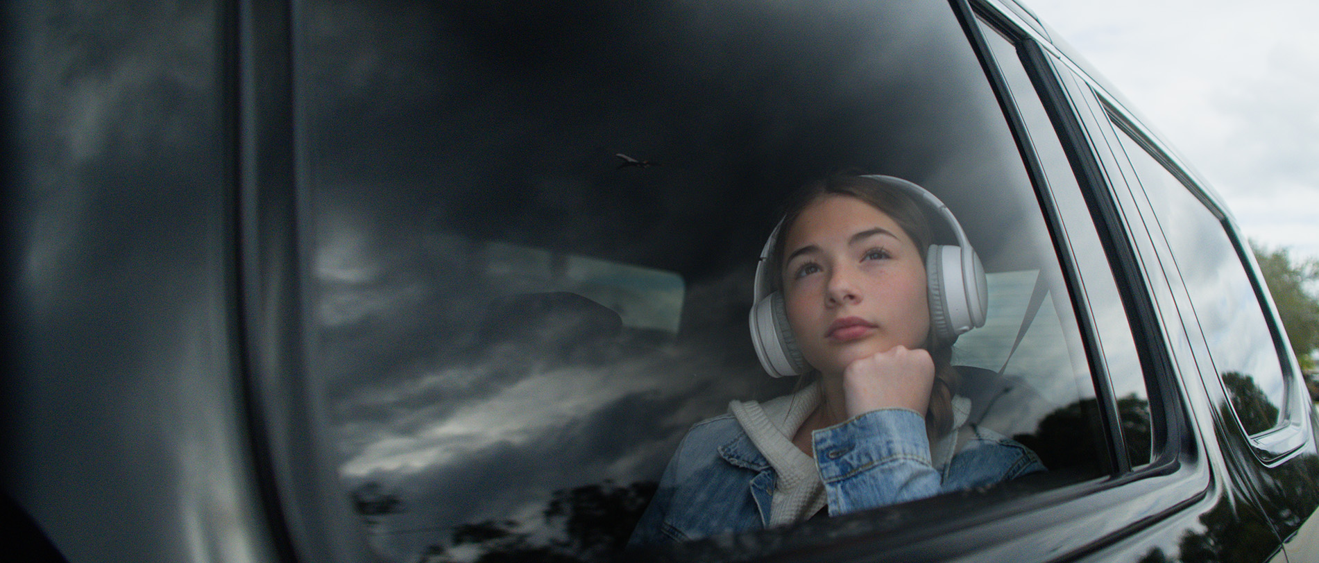 Girl looking our car window