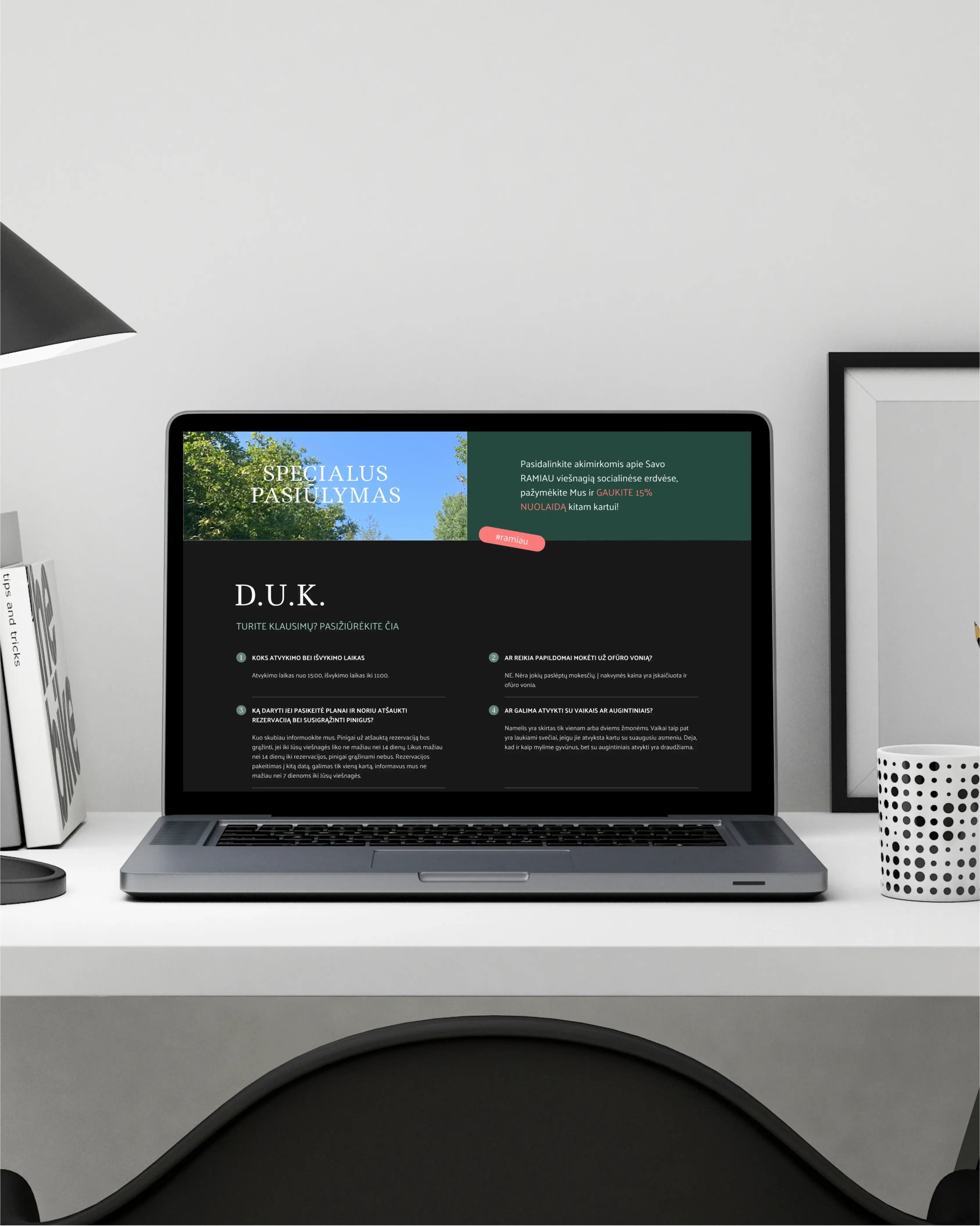 Laptop on white desk displays special offer and FAQ webpage in dark theme with green and blue sections.