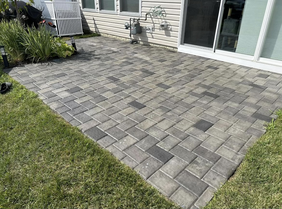 Finished paver patio beside a home