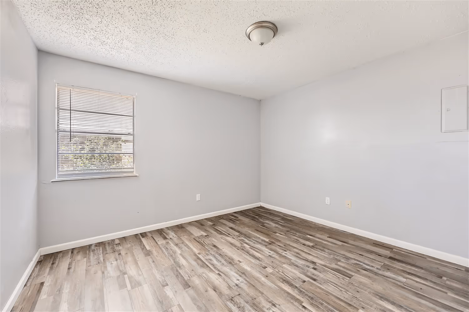 Empty bedroom with wood floors