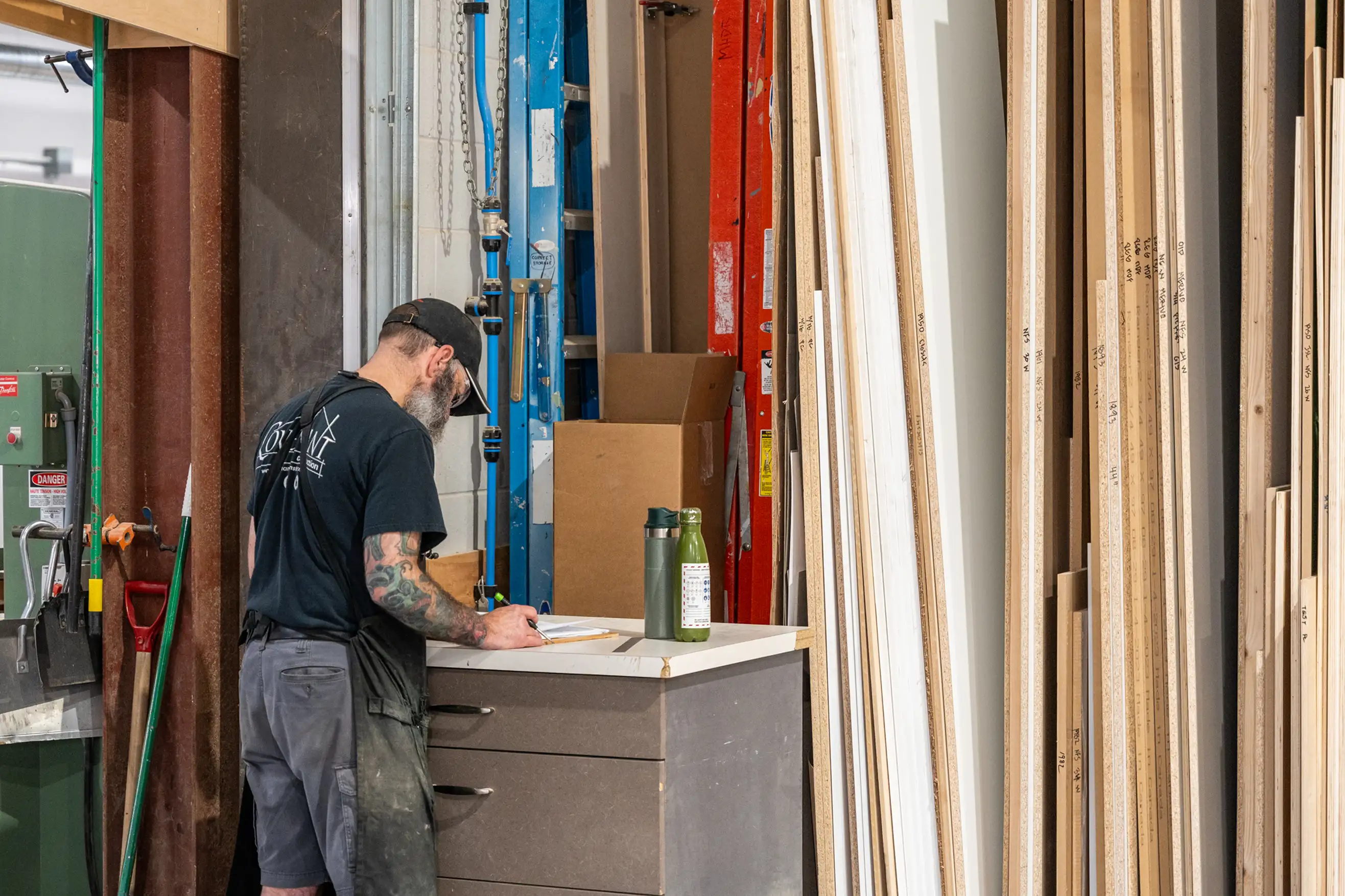 cabinet maker using clamps to hold down wood