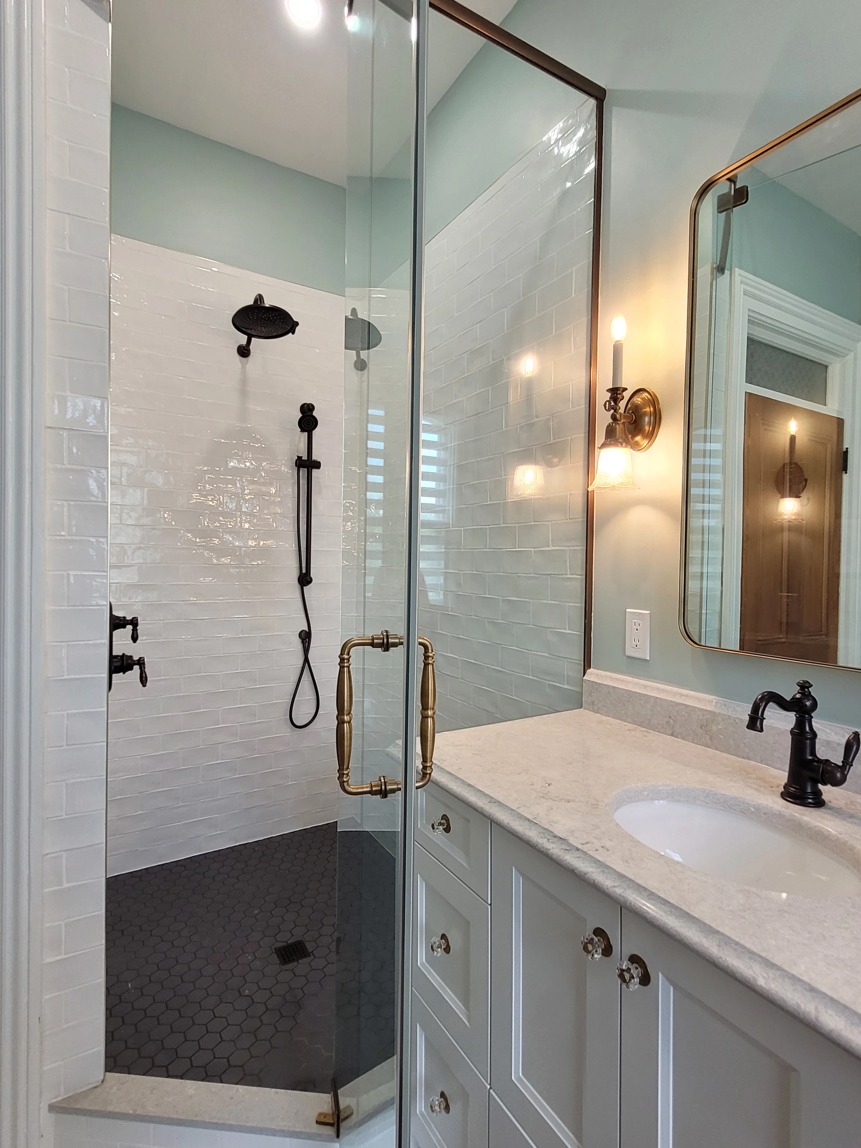 custom kitchen with light cabinets, silver faucets, paintings of pathway