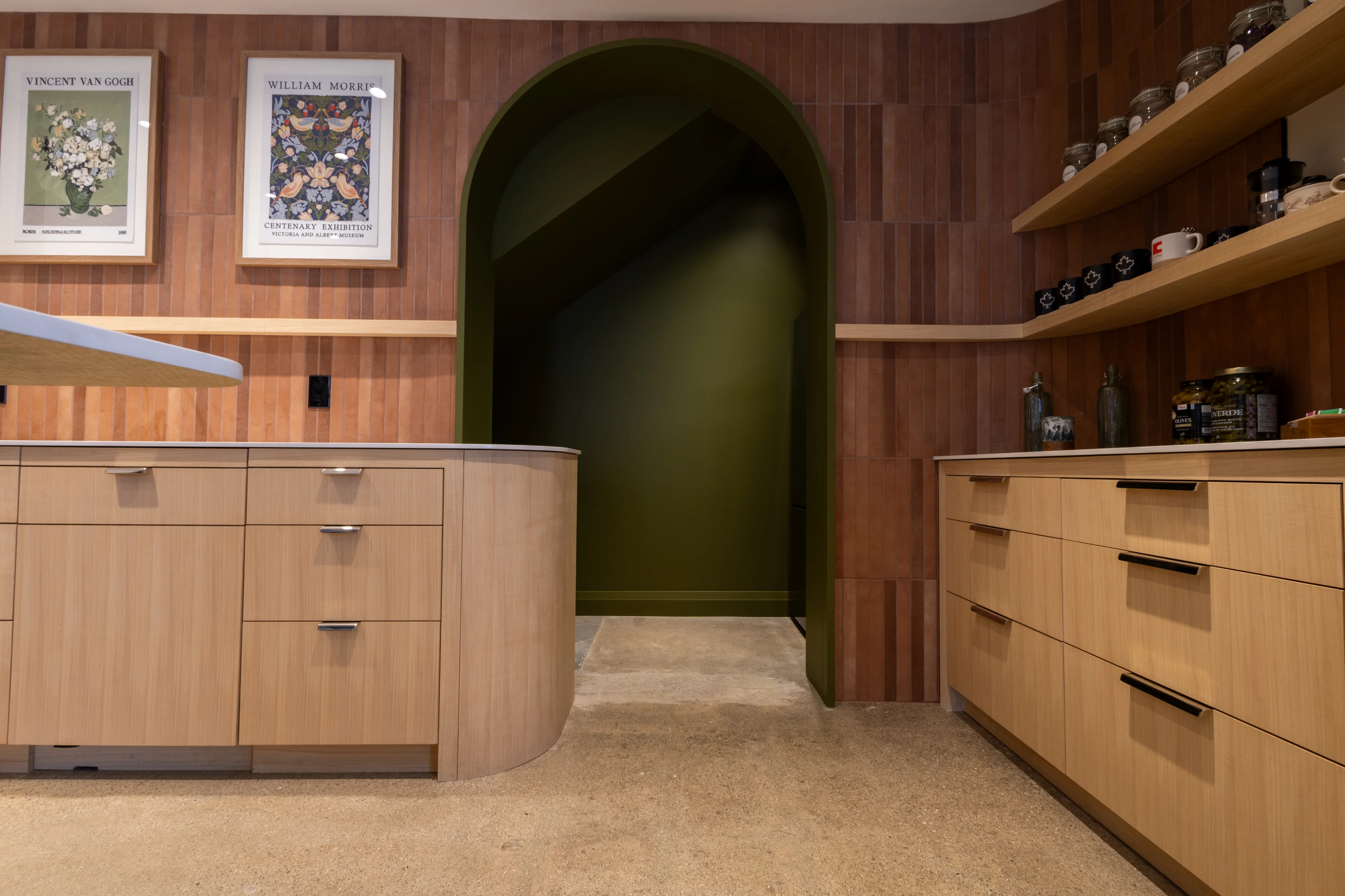 Dark wood interior with green doorway, custom cabinets and shelves, mugs and design accessories