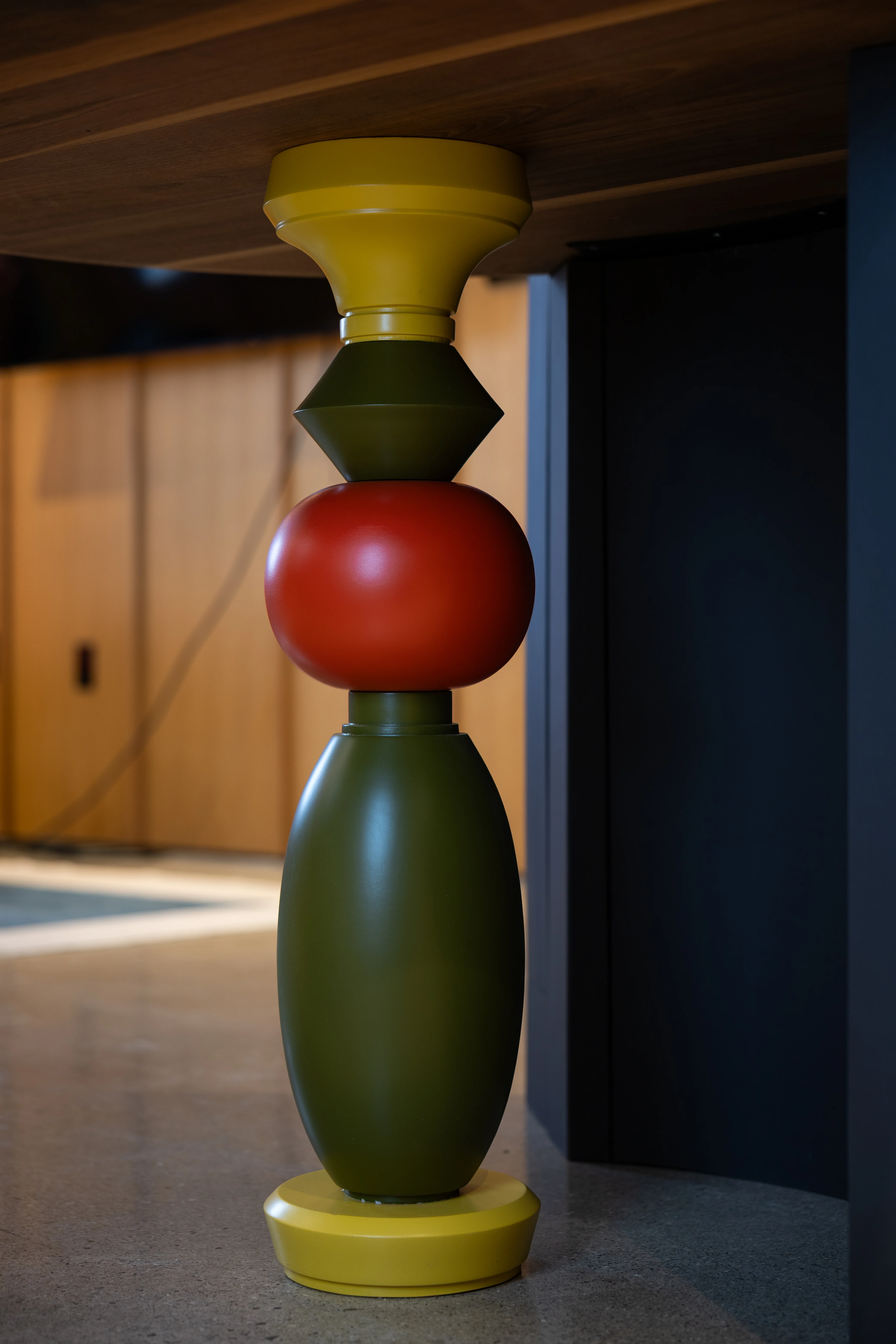 carved table leg, top yellow, middle green, middle red, bottom green