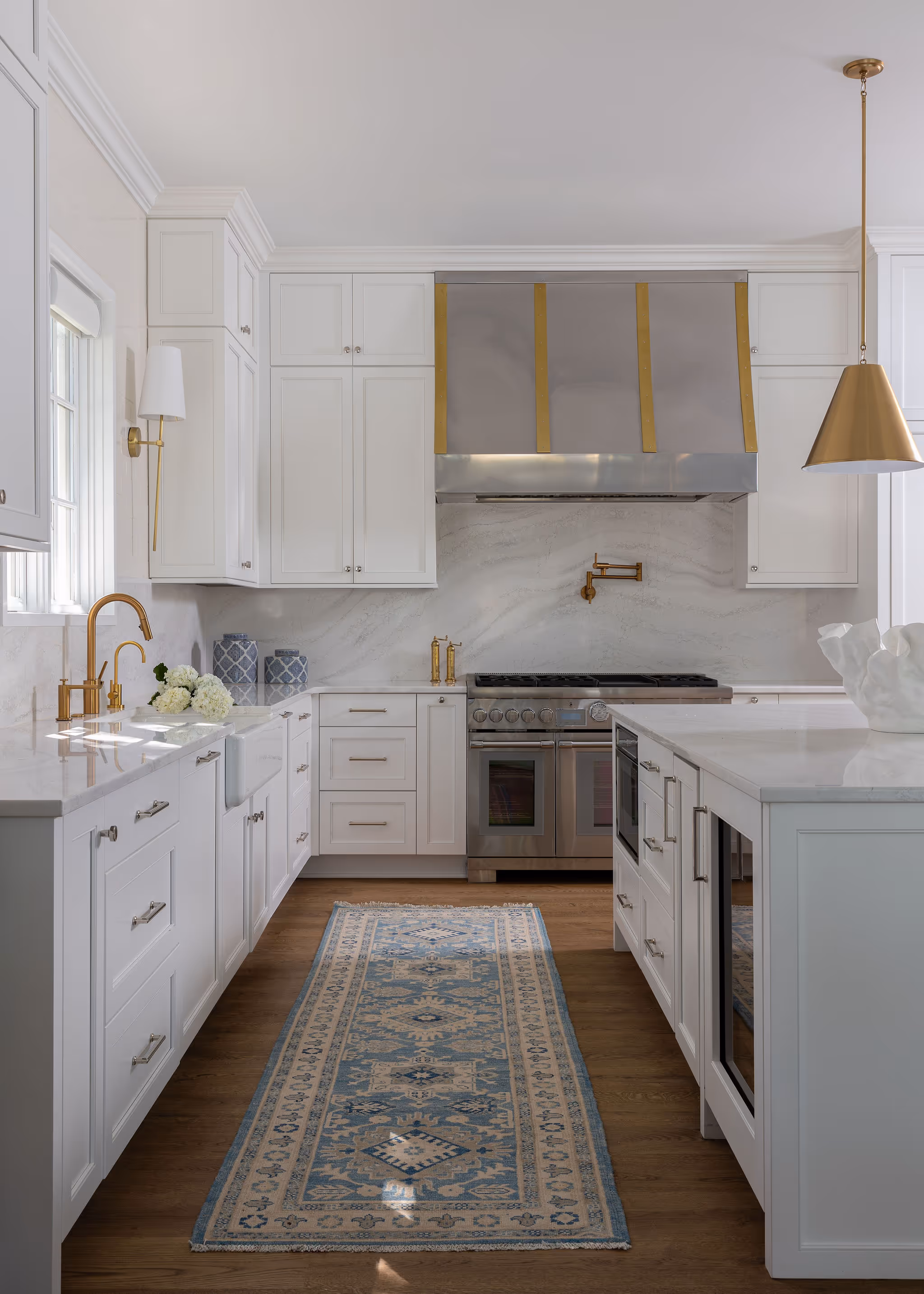 Close‑up of the decorative metal‑strapped range hood and custom cabinetry detail