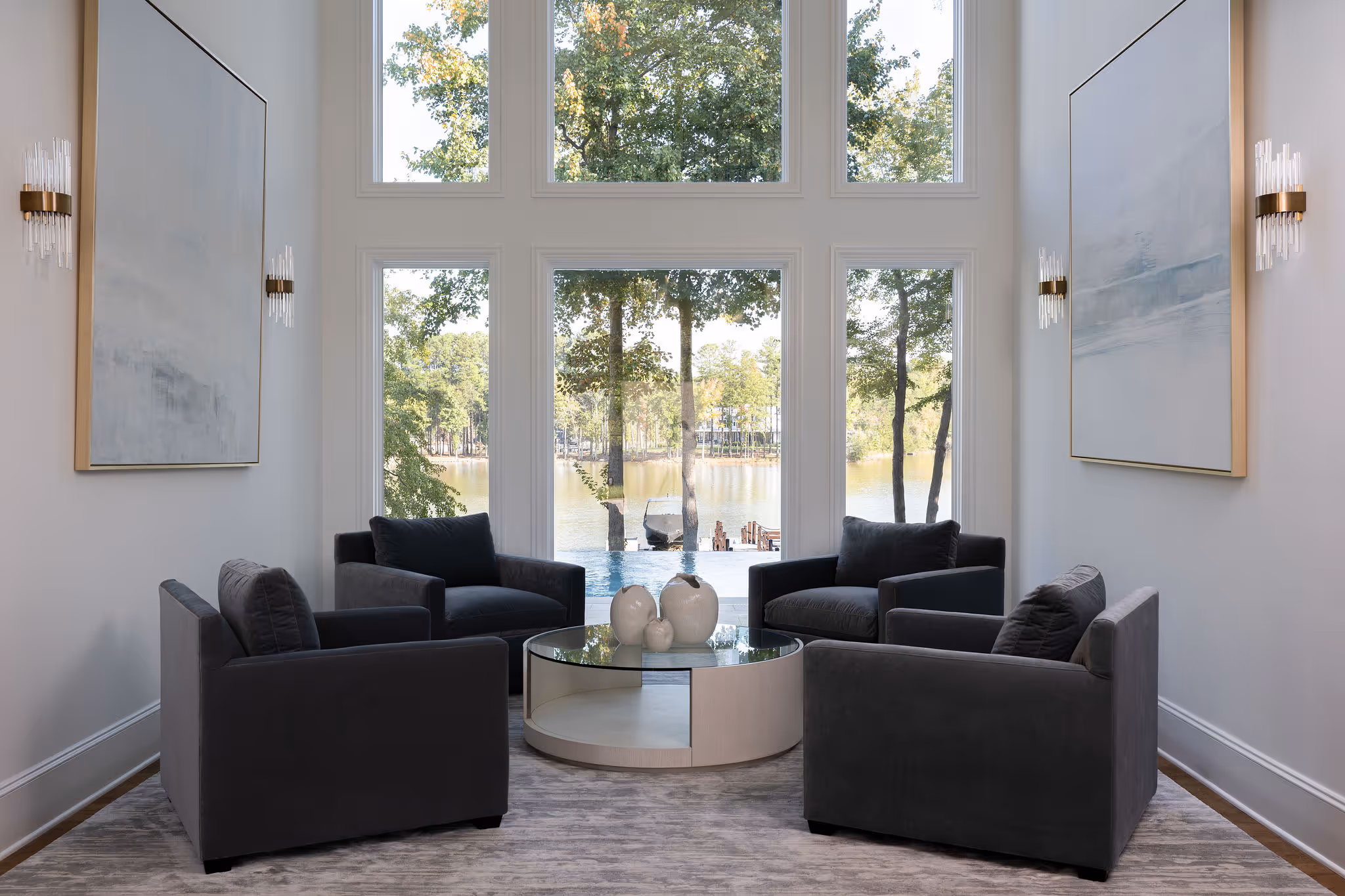 Interior living area with vaulted ceilings, built‑ins, and large windows to outdoor living