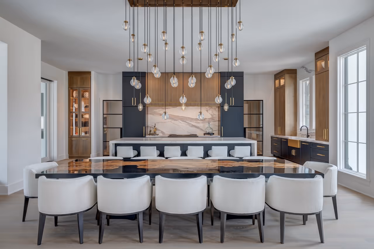 Contemporary kitchen space showcasing a waterfall island, minimalist hardware, and polished hardwood floors.