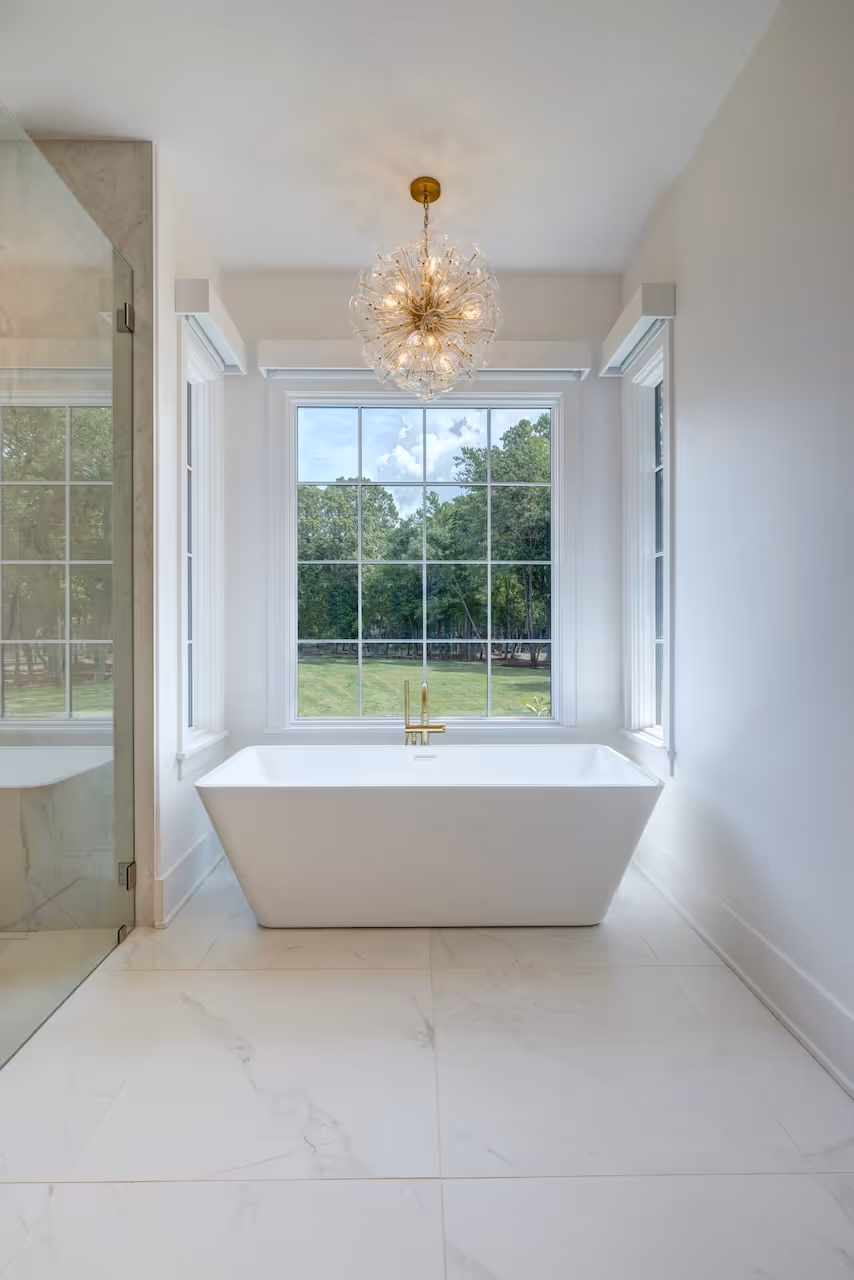 Freestanding tub on marble tile floor