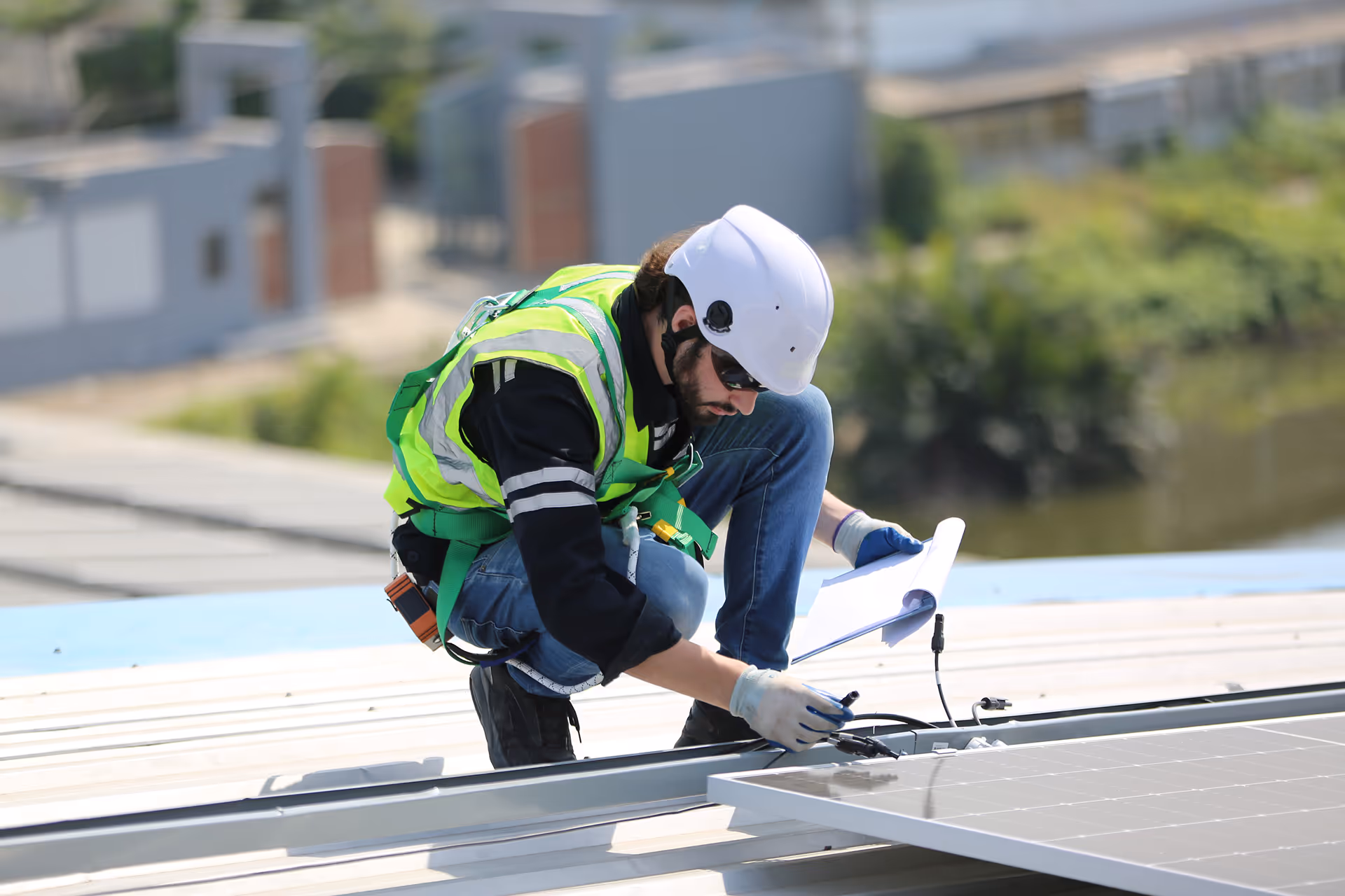 workers-installing-solar-panels-on-warehouse-roof