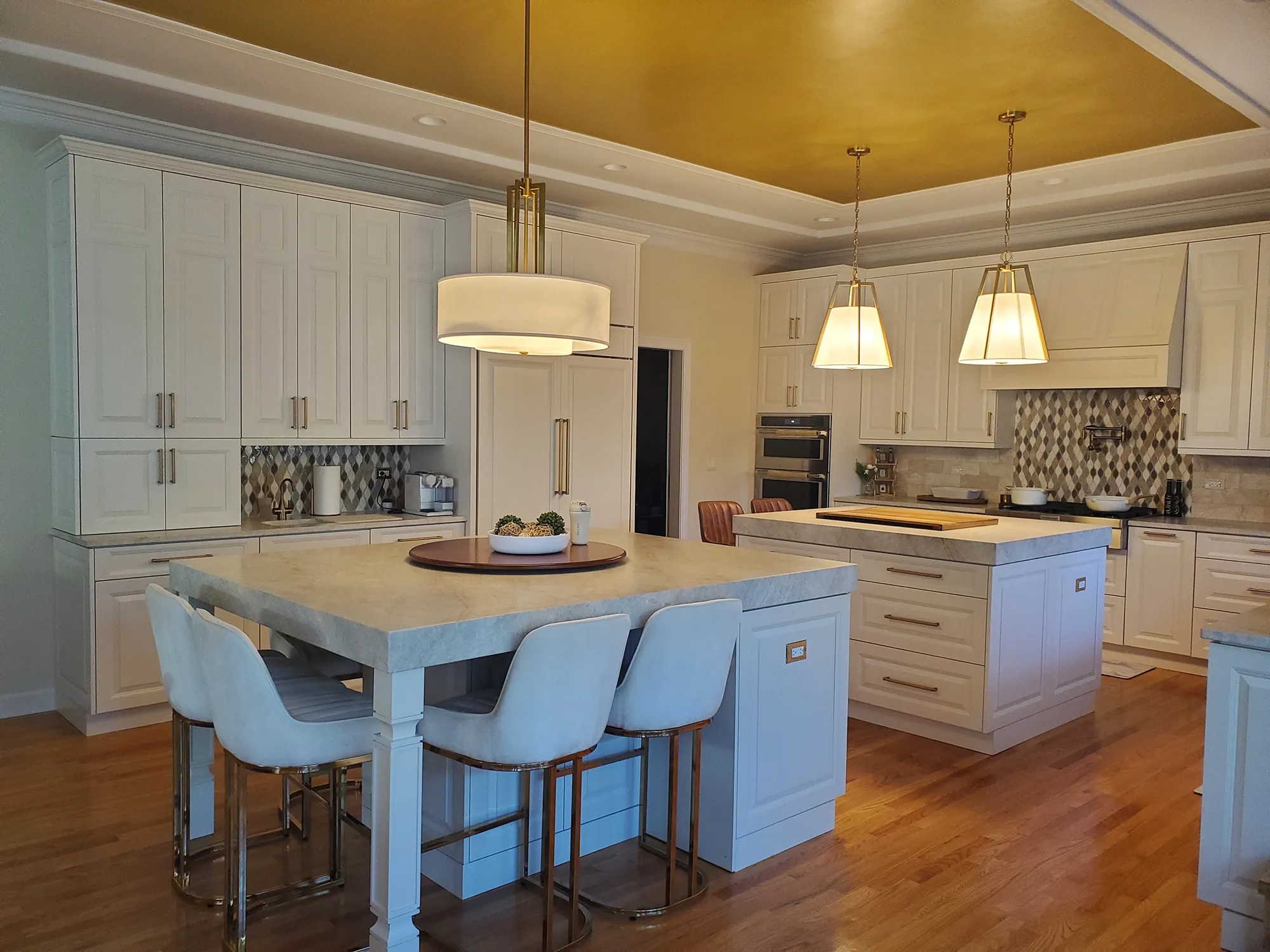 A large kitchen with a center island and white cabinets. Freshly remodeled and painted by Chris Painting and Remodeling