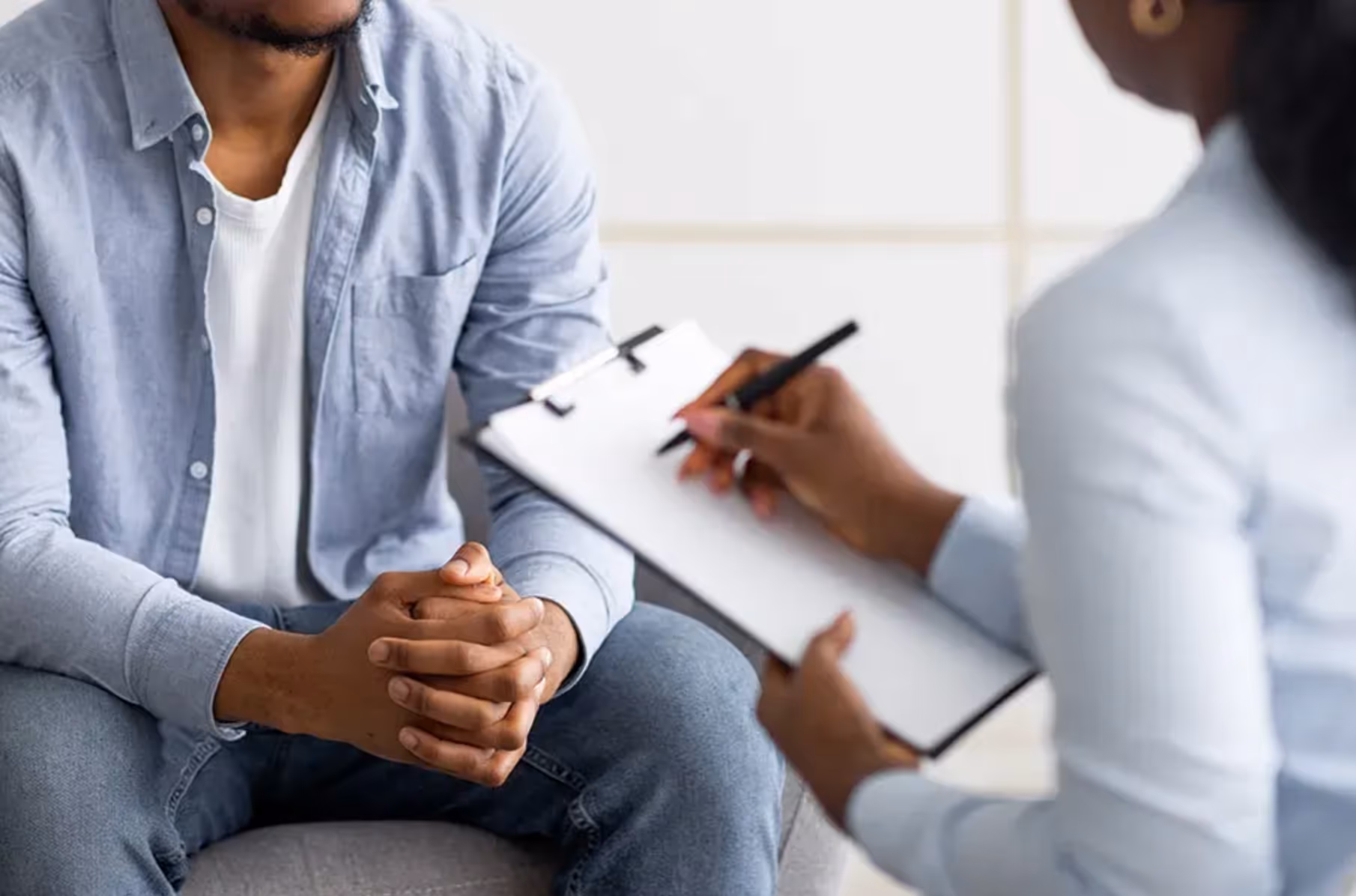 Two people sitting down having a health consultation.