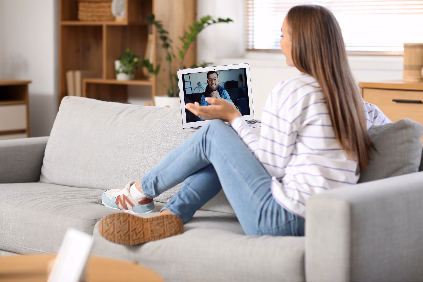 Woman at home on video call attending telehealth