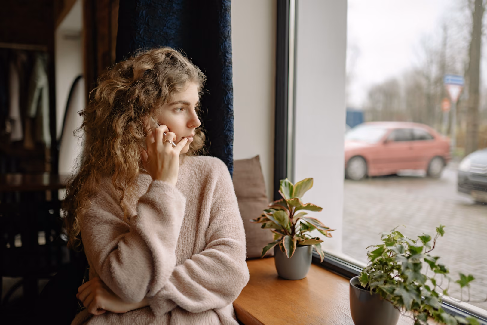 Woman on phone getting support while looking out the window