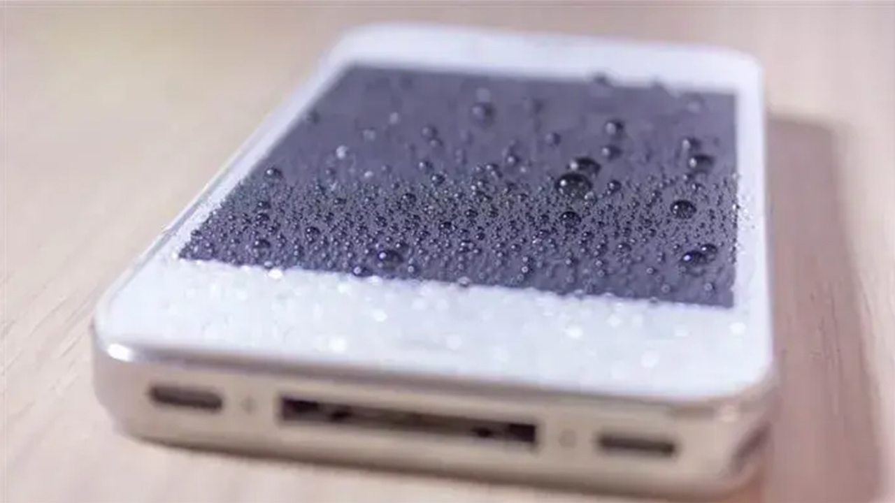 Smartphone covered in water droplets after getting wet