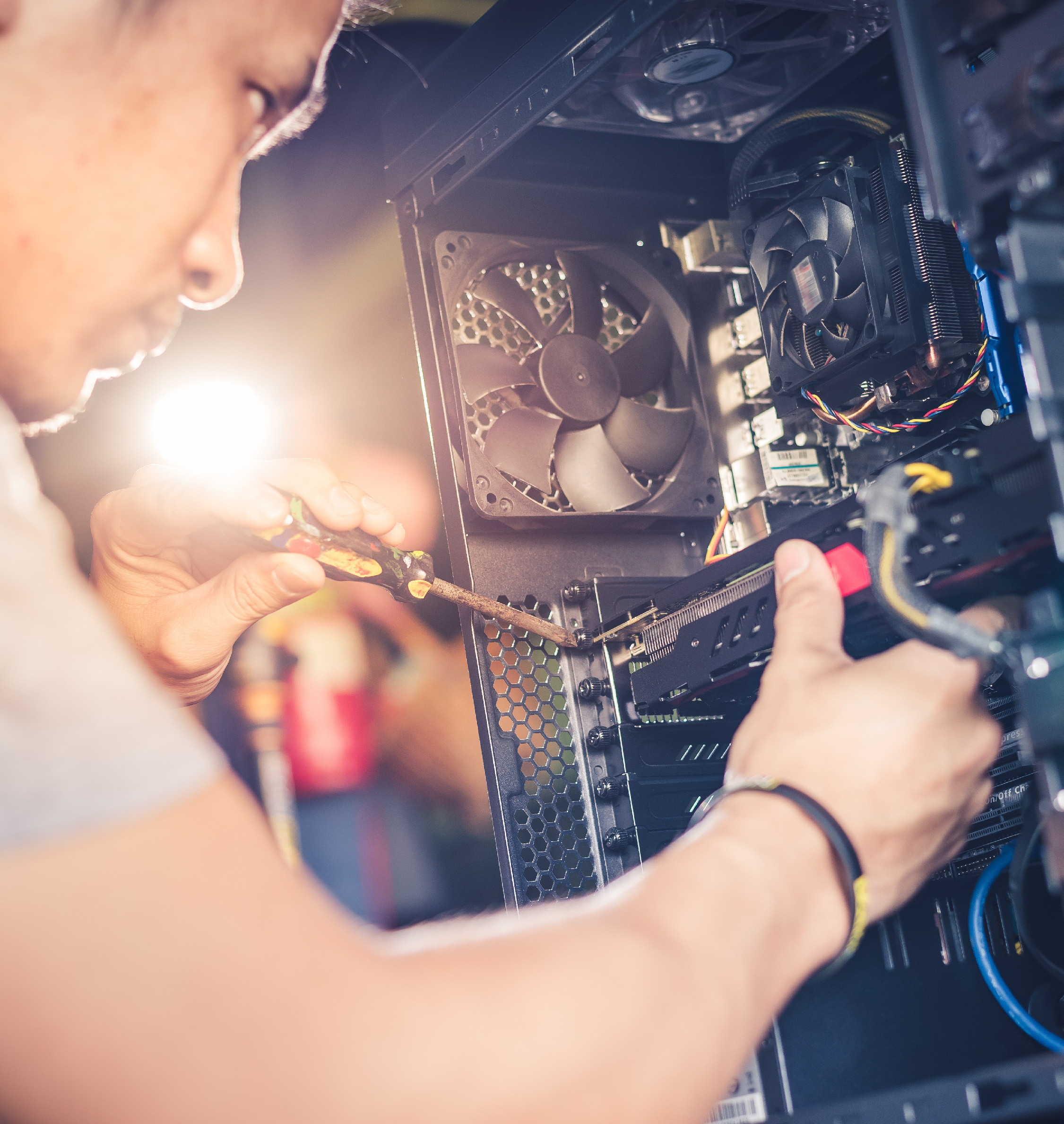 Technician checking a computer cooling fan during repair