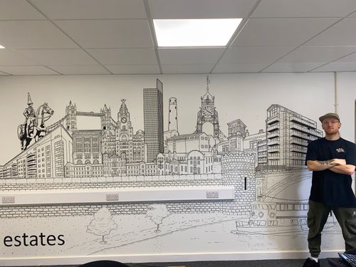 Man stood in front of Mural