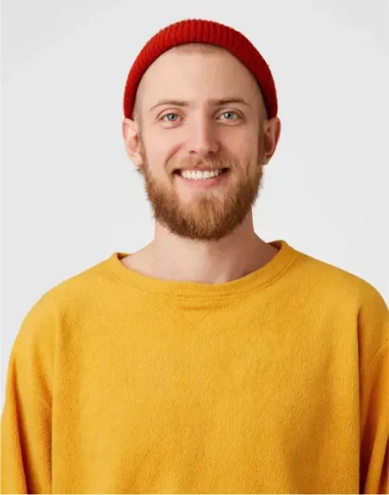 A man with a beard wearing a red hat.