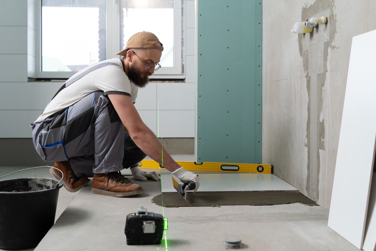 Tile installer installing bathroom and shower tiles