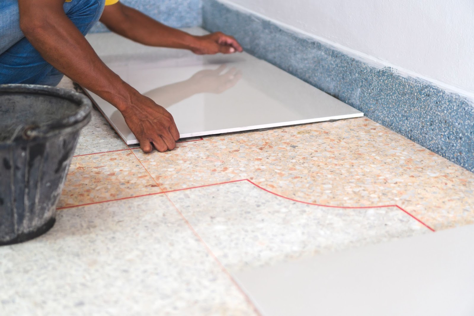 Person attempting a DIY tile installation