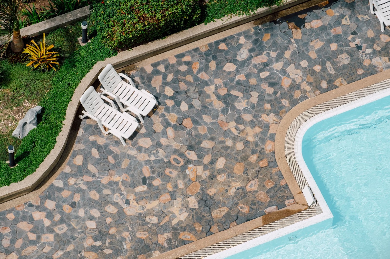 Natural stone paving next to pool