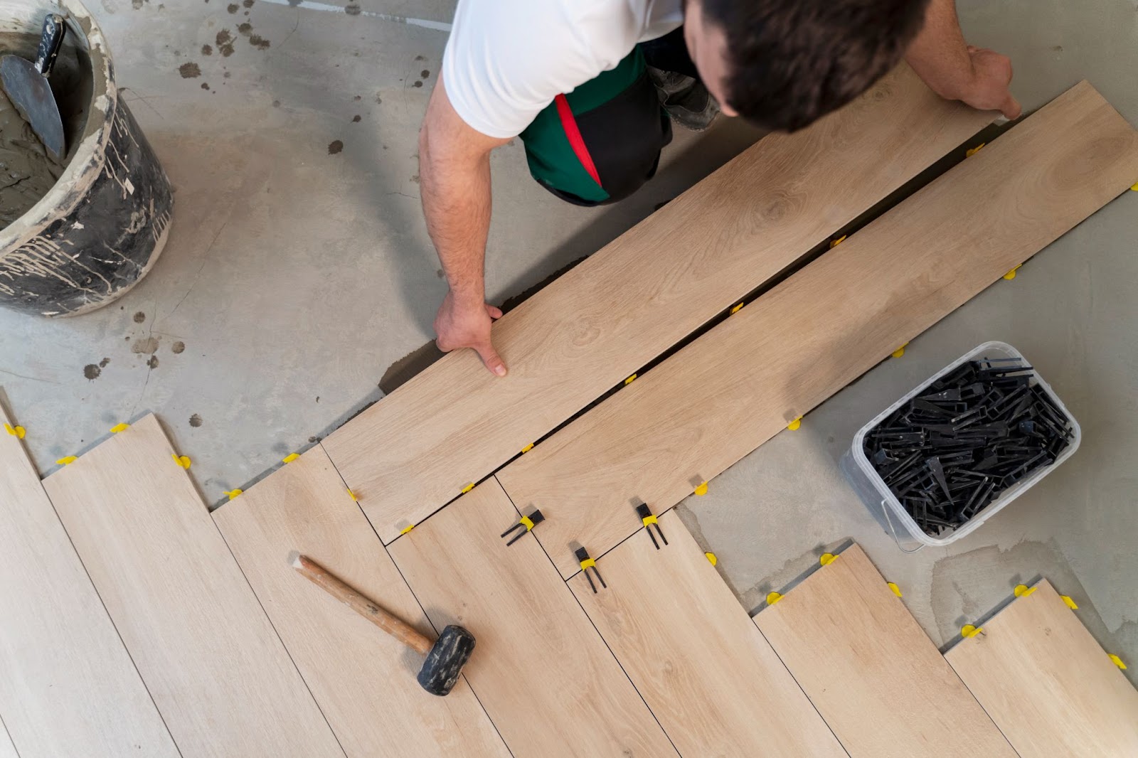 Person installing wooden floor panels