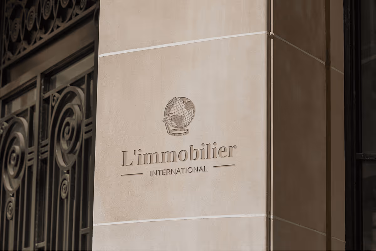 L’Immobilier International sign on a stone façade.