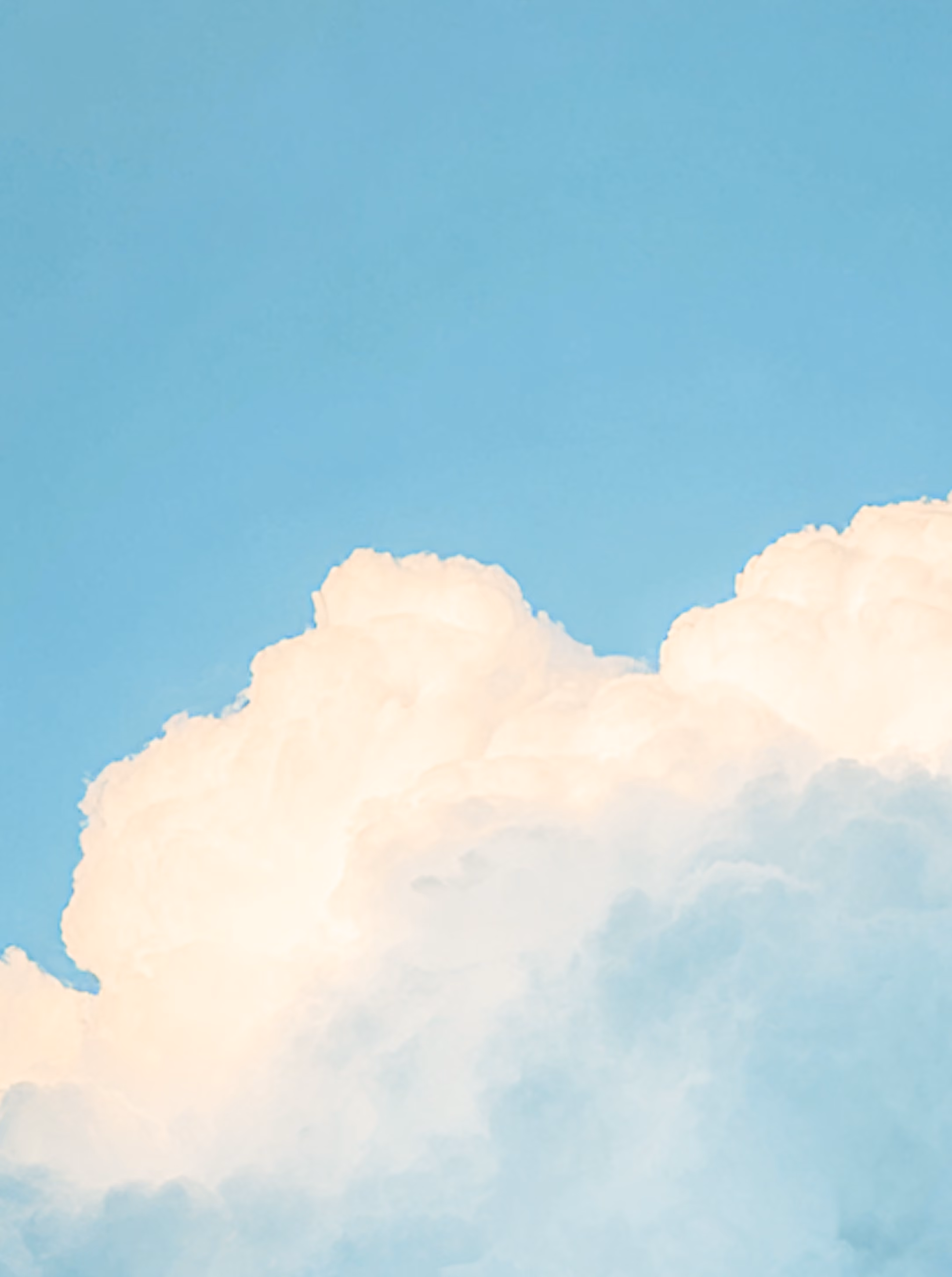 Large fluffy white clouds against a clear blue sky.
