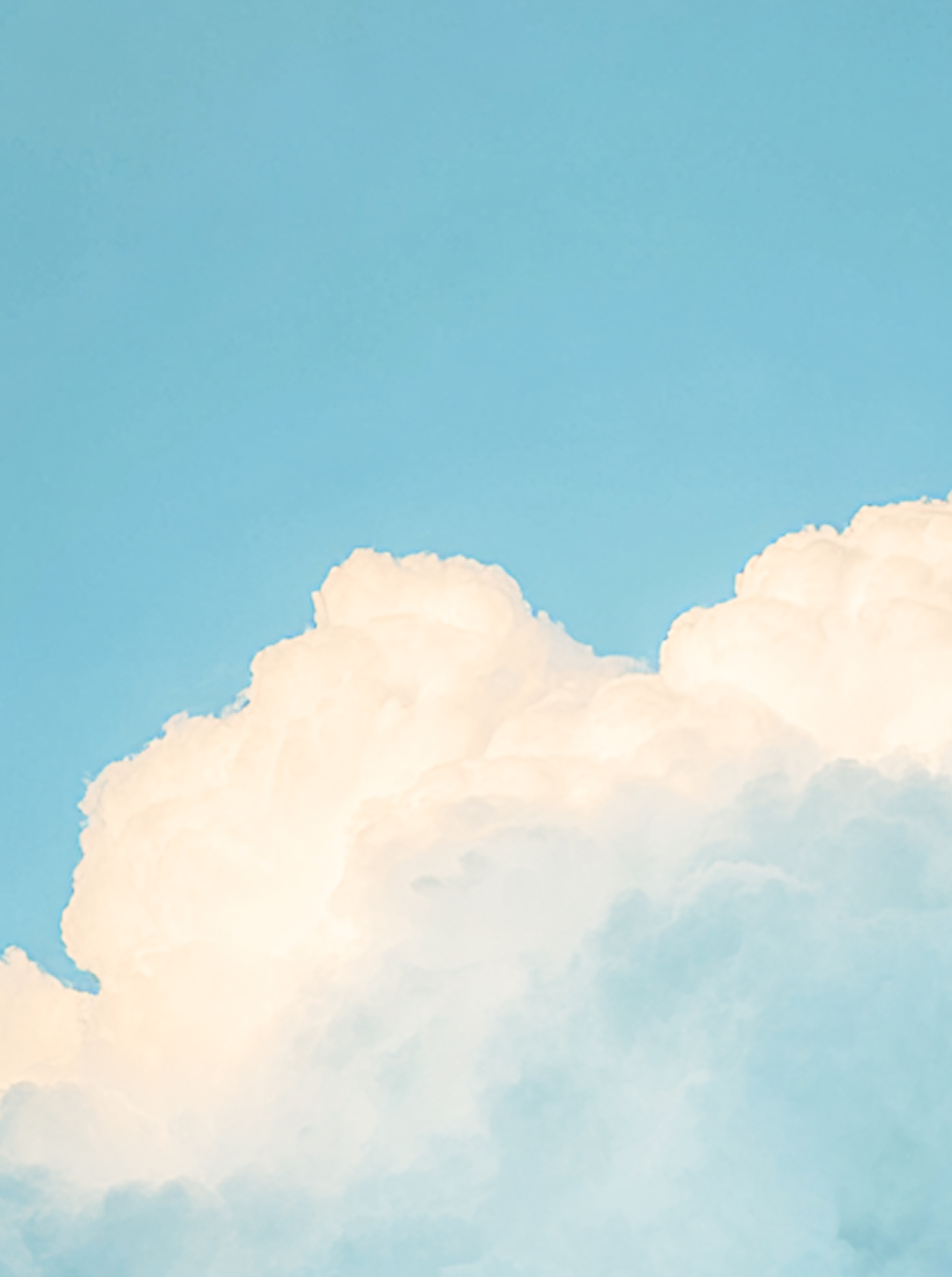 Large fluffy white clouds against a clear blue sky.