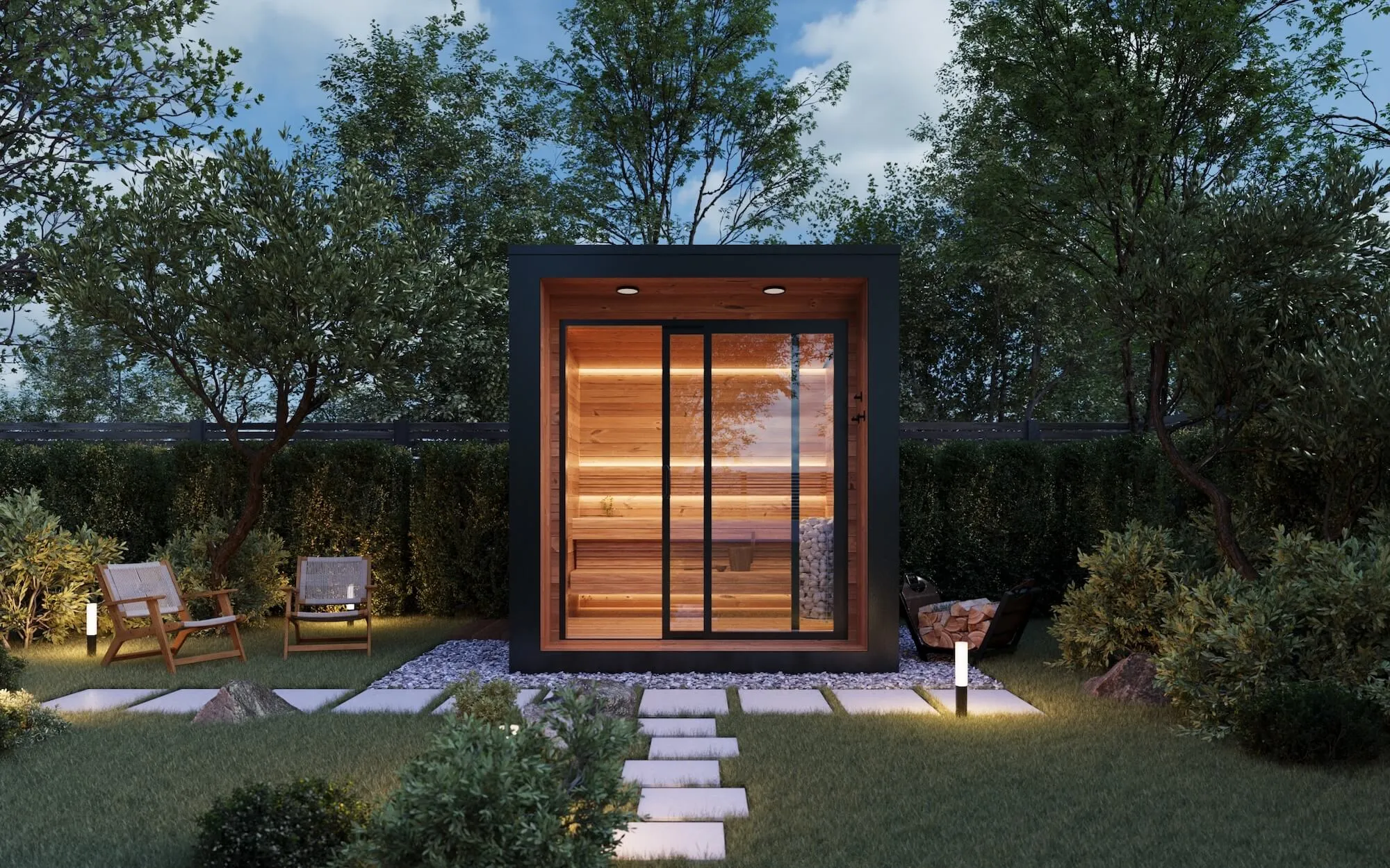 Modern outdoor sauna with glass sliding door glowing warmly inside, surrounded by green trees, shrubs, and two wooden chairs on a lawn with stepping stones.
