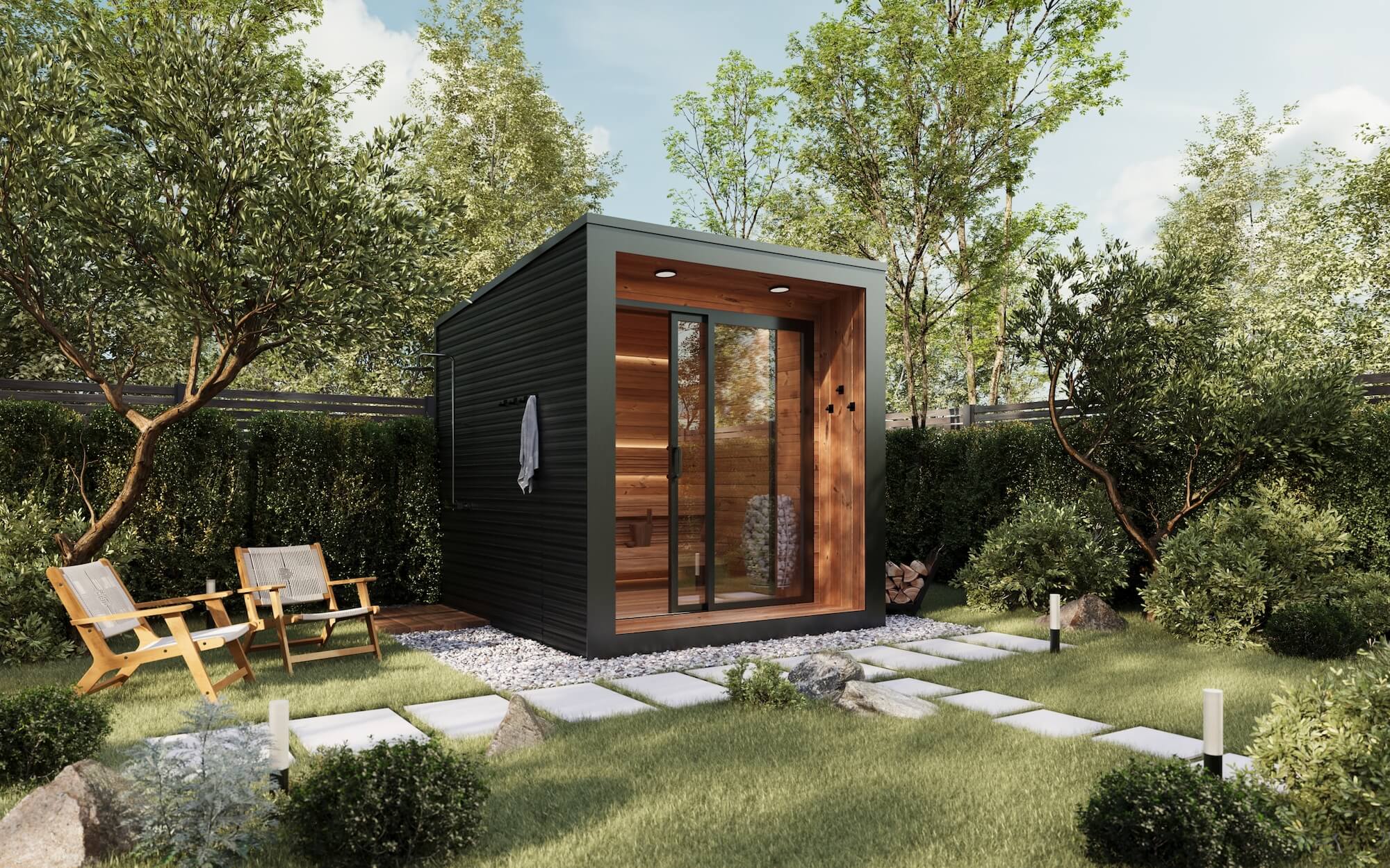Modern backyard sauna with glass door and wood interior, surrounded by green grass, bushes, trees, and two wooden chairs.