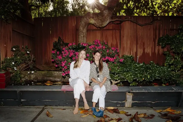 Helpr founders, Kasey and Becka, sitting side by side