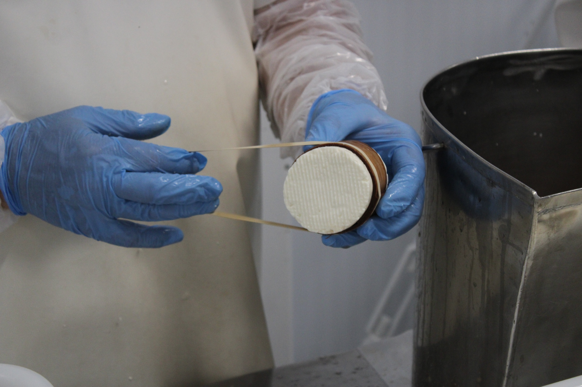 A Montebello cheesemaker preparing Adoray
