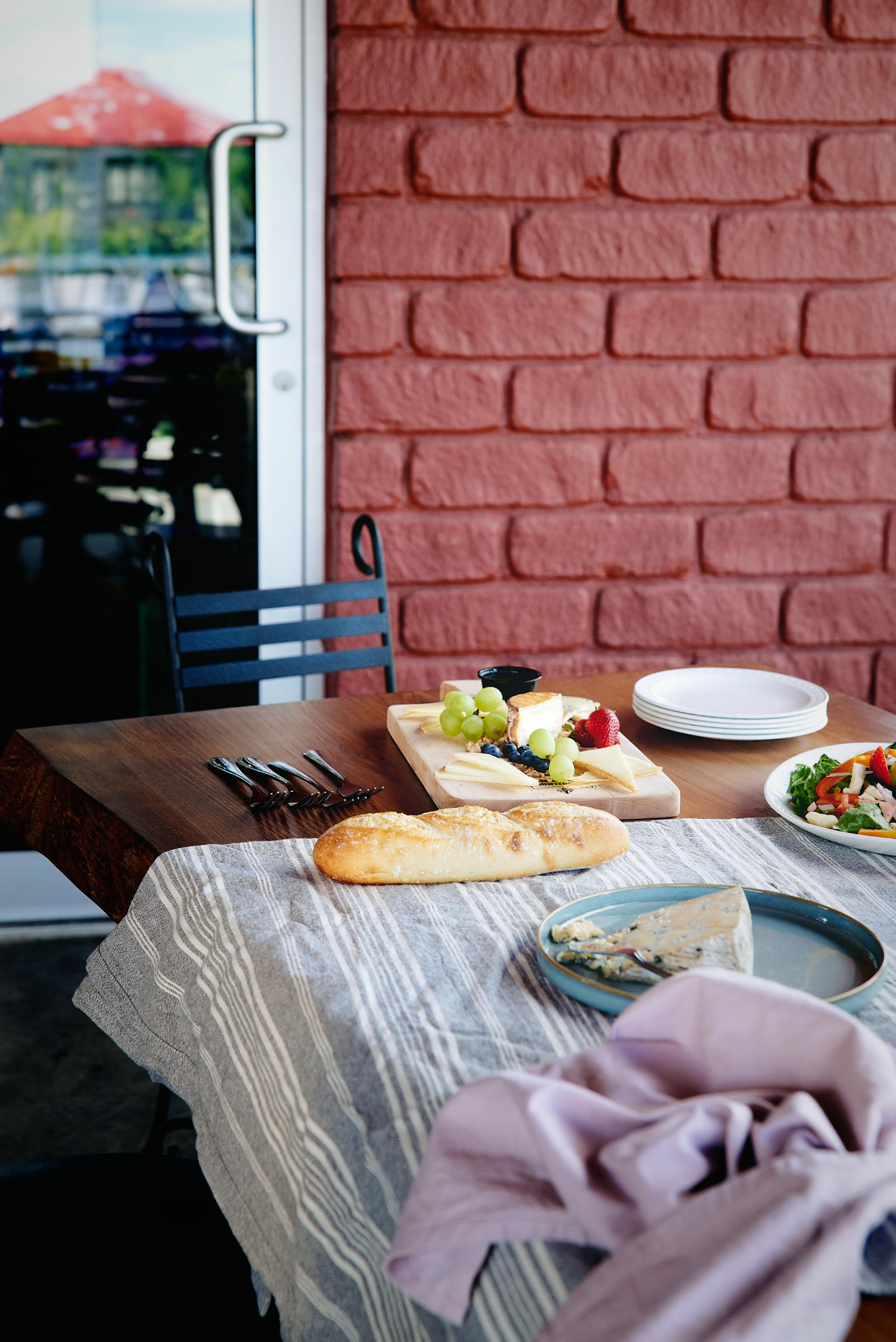 Fromagerie Montebello boutique table beside a red brick wall