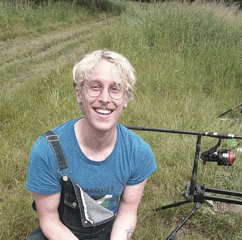A picture of a blond man in overalls