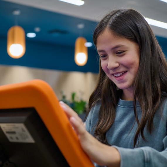 Young teen playing with Quest device.